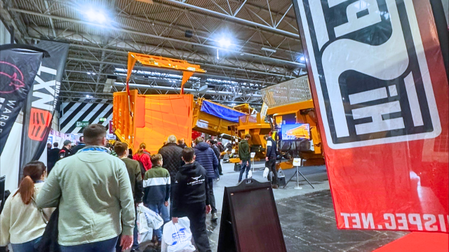 Visitors walking through the LAMMA 2026 exhibition hall at the NEC Birmingham, viewing agricultural machinery and technology displays.